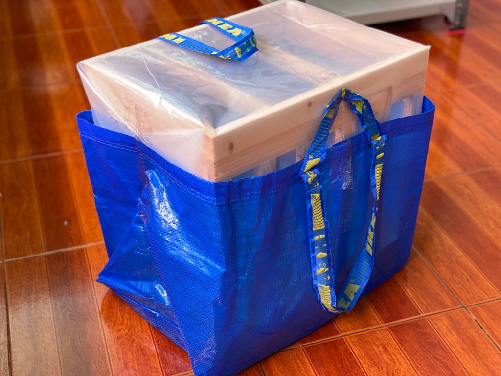 A hydroponic unit packed into a blue carry bag for delivery